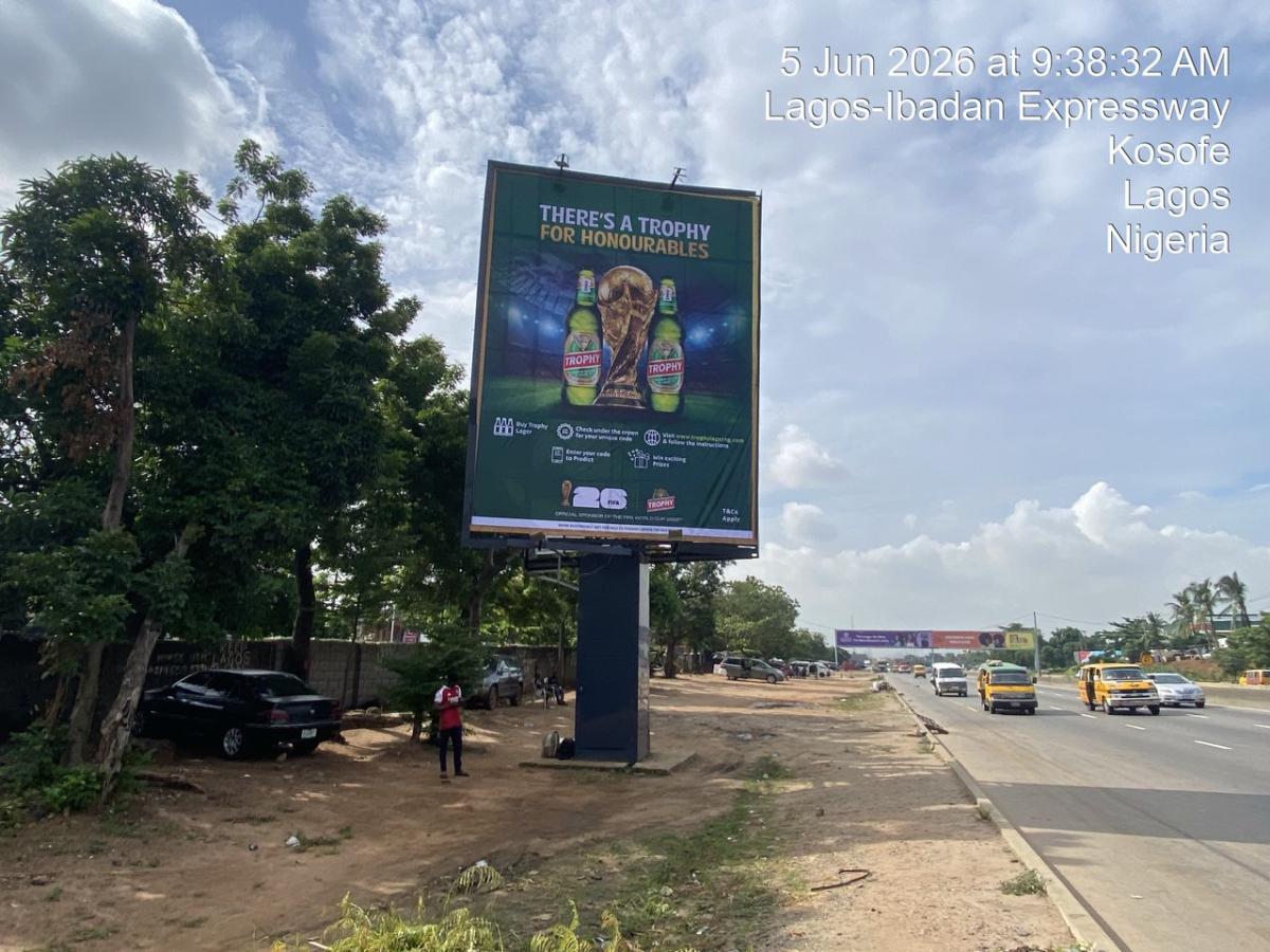 A front-lit static billboard located at Tollgate/7up by Magodo on the Lagos–Ibadan Expressway, facing traffic from Berger The board is double-sided and each side is rented separately.