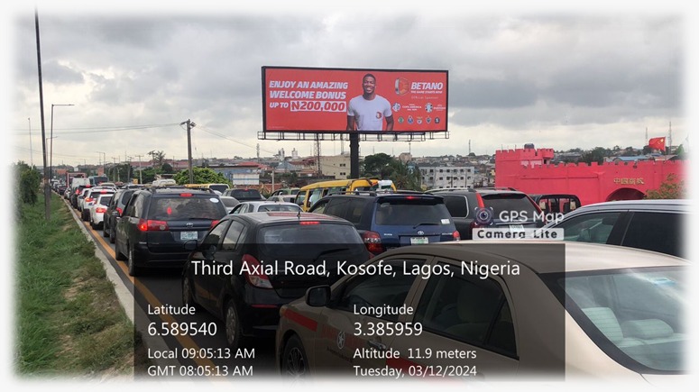 BB Way by China Town Bus Stop, Facing Traffic Towards 3rd Mainland Bridge, Ojota, LagosThat’s the location listed for the billboard.It’s right at China Town Bus Stop on IBB Boulevard/Ojota, on the side facing traffic heading to the 3rd Mainland Bridge.