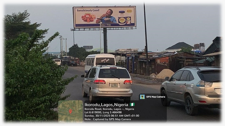 A double-sided unipole billboard located at Majidun Awori Bus Stop on Ikorodu Road, directly by the LAMATA Depot.