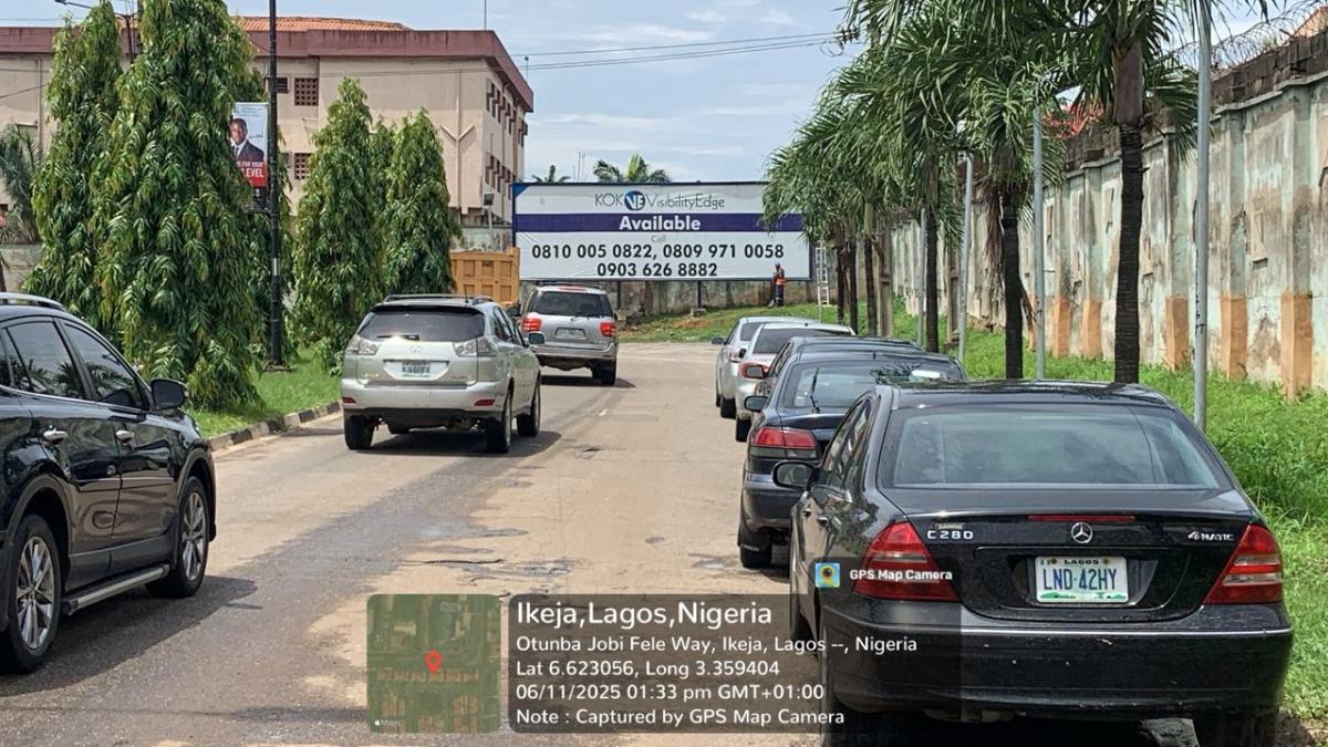 Large outdoor advertising billboard along Otunba Jobi Fele Way, after Gani Fawehmi Library, behind the M.K.O Abiola Garden fence, Ikeja, Lagos. Positioned in a high-traffic commercial area, it offers strong visibility for businesses 